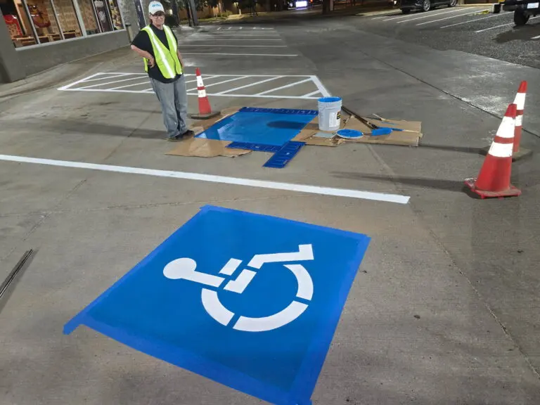 Parking symbol being painted at night