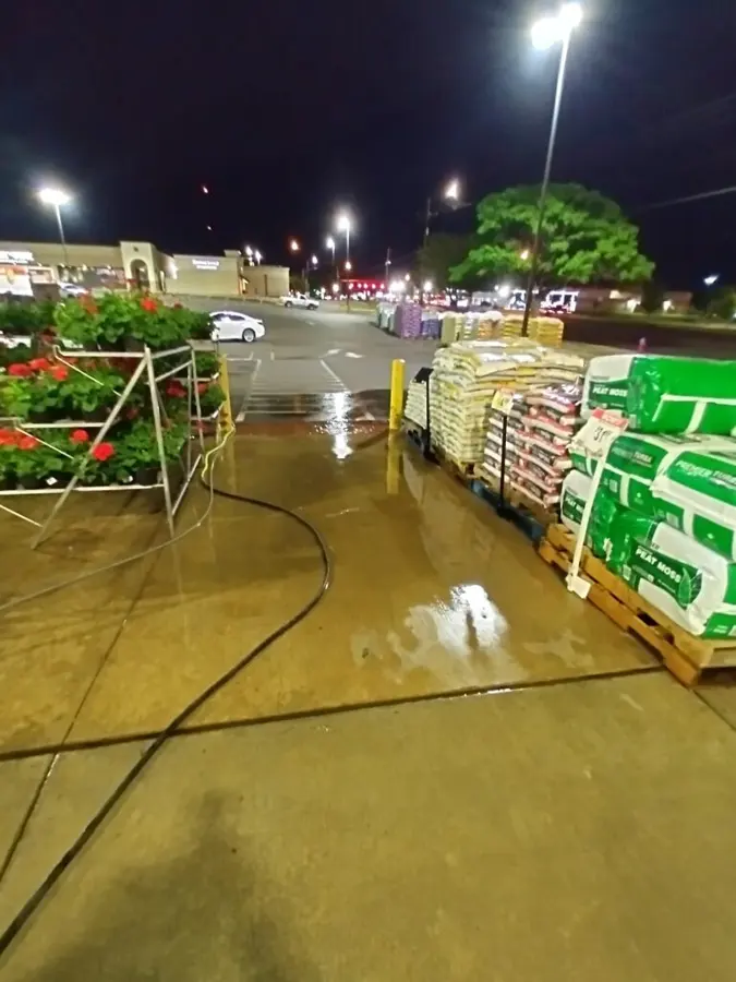 Concrete walkway beside a garden center