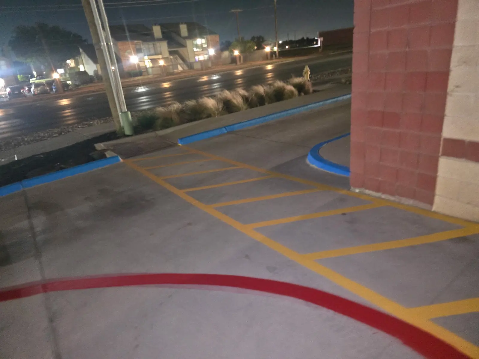 Yellow crosshatch and a red fire lane beside a building