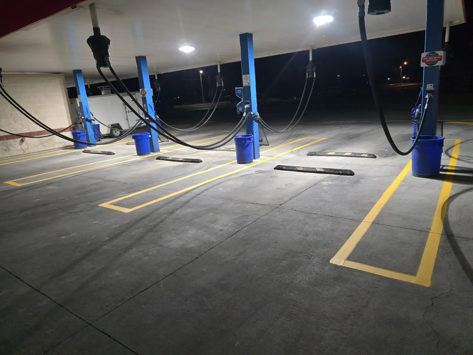 Yellow parking stall lines under a canopy