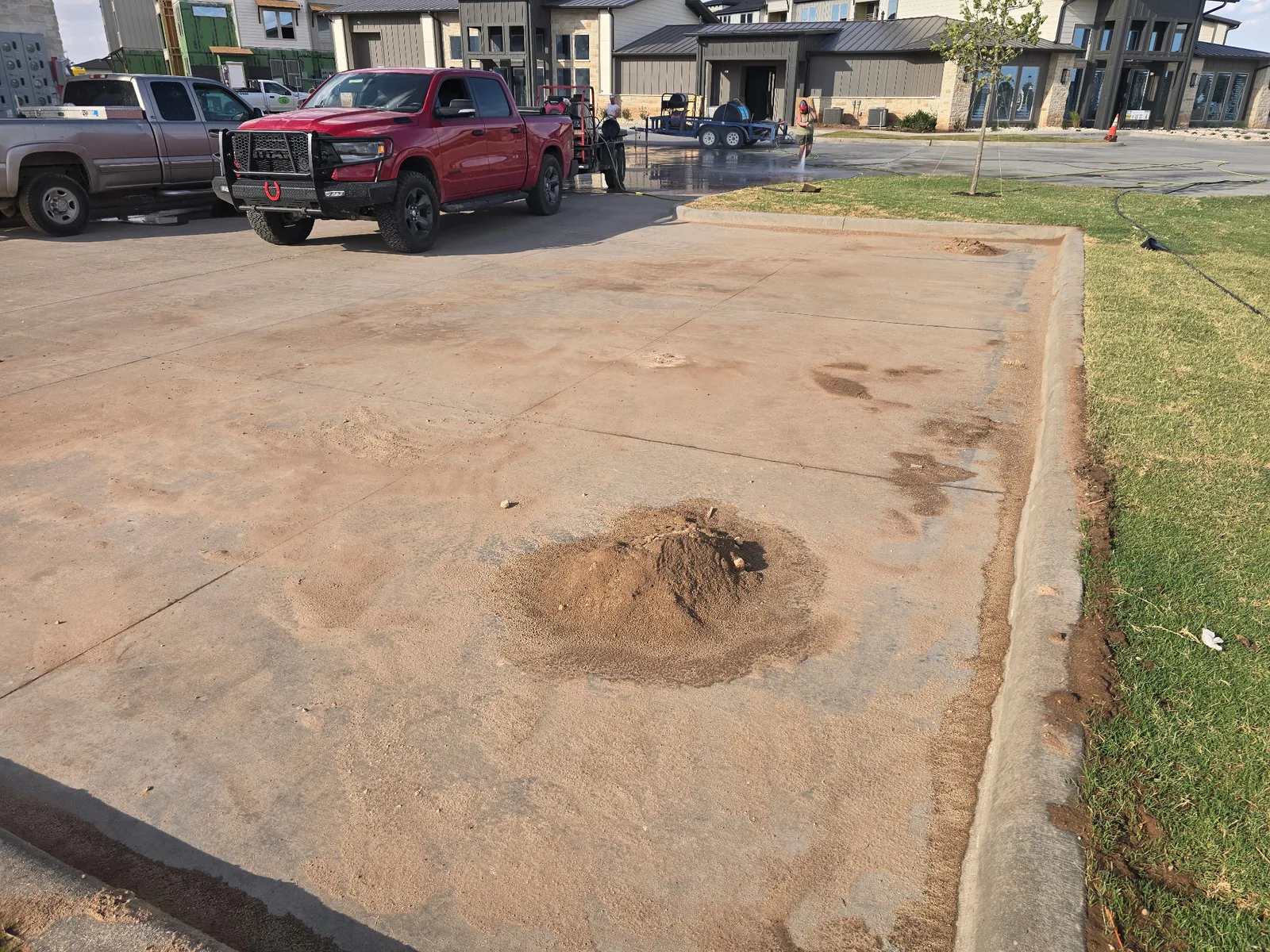 Before: construction dirt piled on a concrete pad