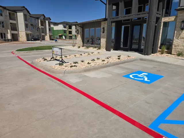 Red curb sweeping to the accessible space at the entrance