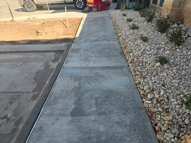 Clean sidewalk beside the rock bed