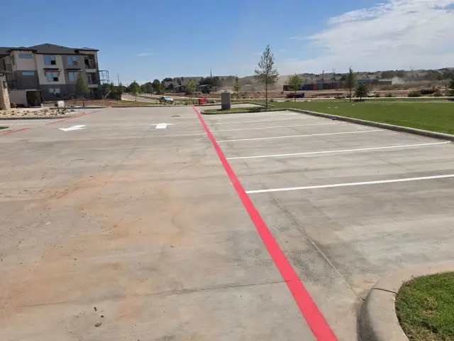 White parking stalls and a red fire lane