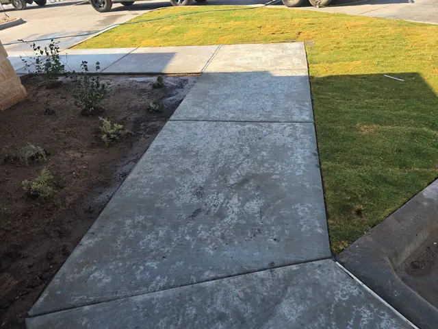 Clean sidewalk and new lawn
