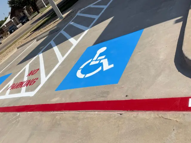Accessible symbol and NO PARKING aisle, close up